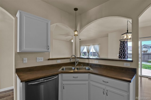 9455 Shinnecock Ct, Peyton, CO 80831 - kitchen featuring stainless steel dishwasher, a sink, arched walkways, a ceiling fan, and white cabinets