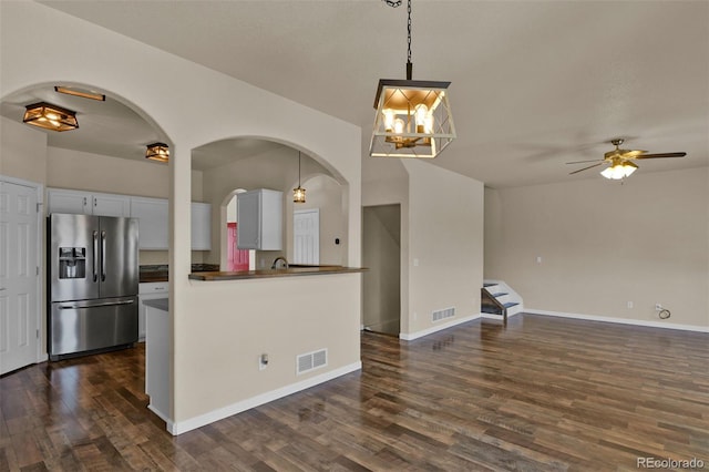 9455 Shinnecock Ct, Peyton, CO 80831 - kitchen featuring stainless steel fridge with ice dispenser, dark countertops, dark wood finished floors, open floor plan, and a ceiling fan