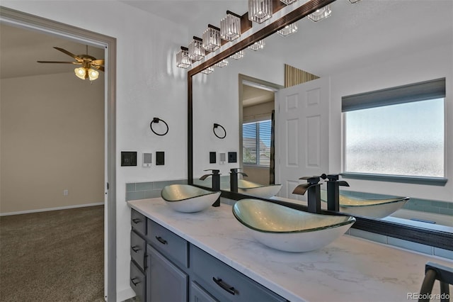 9455 Shinnecock Ct, Peyton, CO 80831 - full bathroom with double vanity, a ceiling fan, and baseboards