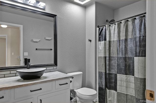9455 Shinnecock Ct, Peyton, CO 80831 - bathroom featuring vanity, a textured wall, toilet, and a shower with curtain