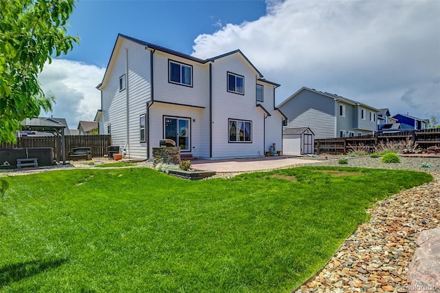9455 Shinnecock Ct, Peyton, CO 80831 - rear view of house with a patio and a hot tub