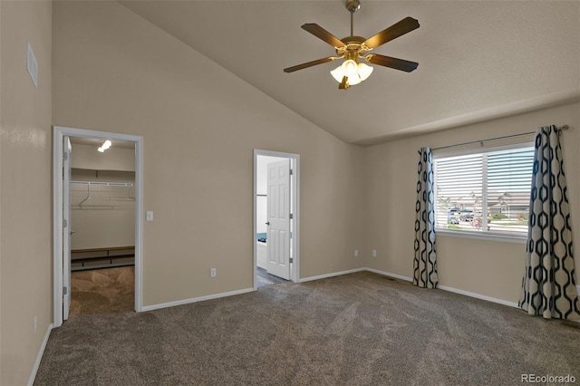 9455 Shinnecock Ct, Peyton, CO 80831 - unfurnished bedroom with carpet floors, a walk in closet, baseboards, and high vaulted ceiling