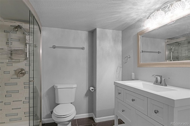 9455 Shinnecock Ct, Peyton, CO 80831 - bathroom featuring a shower stall, vanity, toilet, a textured ceiling, and baseboards