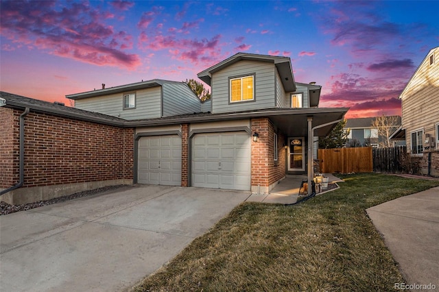 view of property with a garage and a lawn