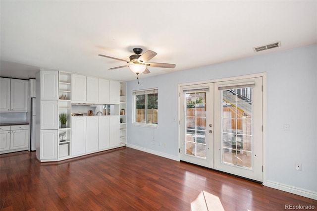 interior space with french doors, ceiling fan, and dark wood-type flooring