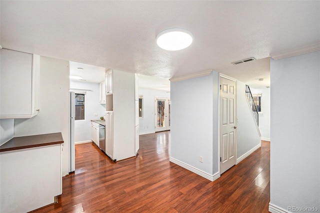 interior space with dark wood-type flooring and a textured ceiling