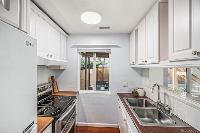 kitchen featuring sink, double oven range, white cabinets, dark hardwood / wood-style flooring, and white fridge