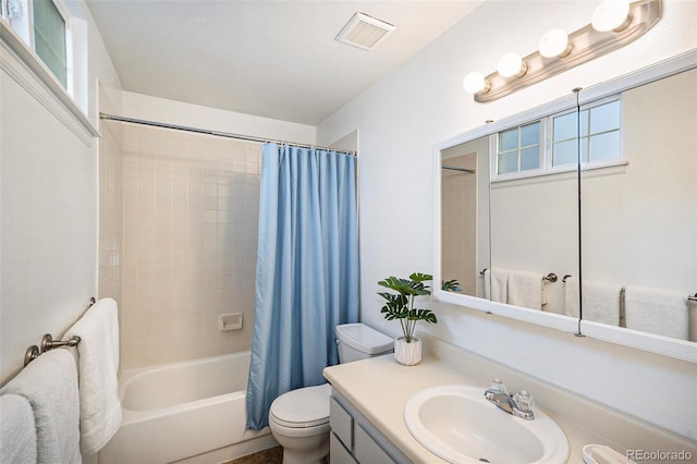 full bathroom featuring vanity, shower / bath combination with curtain, and toilet