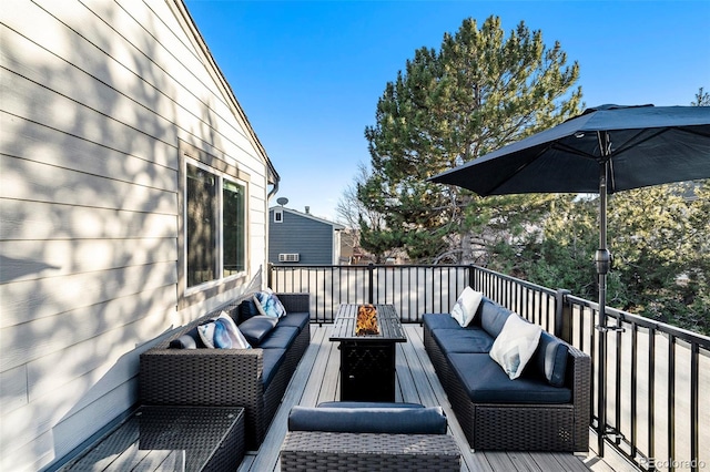 wooden terrace with an outdoor living space with a fire pit