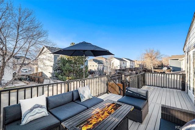 wooden deck with a fire pit