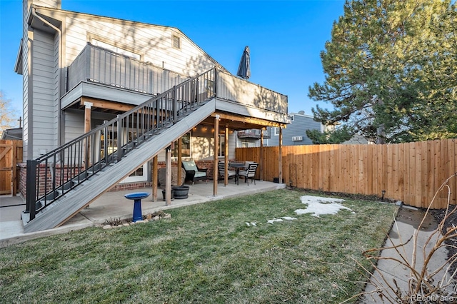 back of house featuring a lawn and a patio