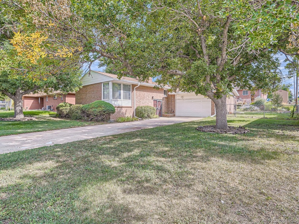 view of front of house with a front yard and a garage