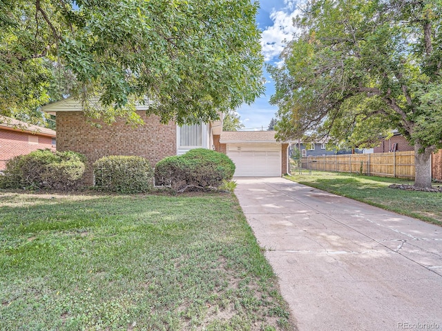 view of property hidden behind natural elements featuring a front yard