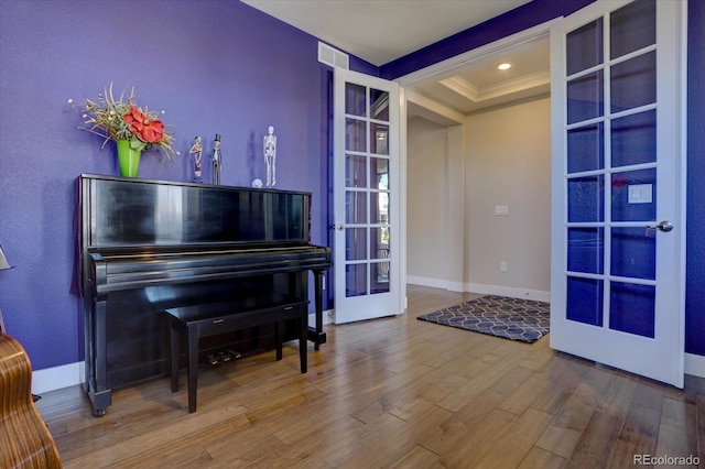 misc room with french doors, ornamental molding, and hardwood / wood-style flooring