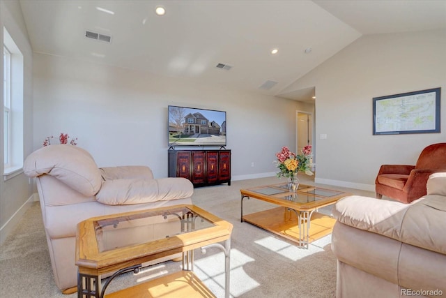 living room featuring lofted ceiling and light carpet