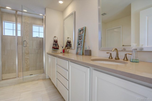 bathroom featuring vanity and a shower with shower door