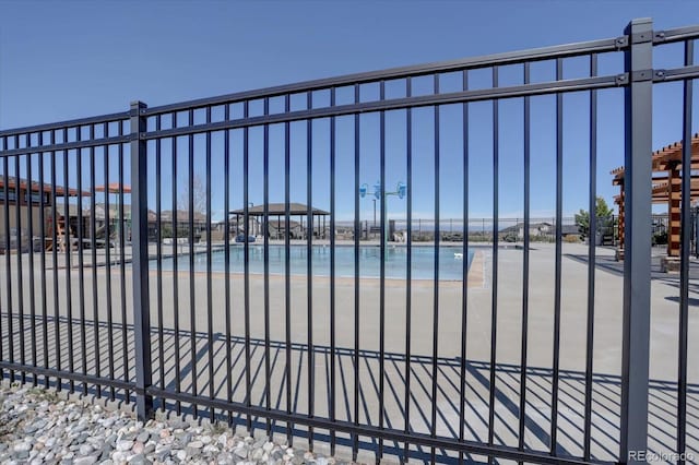 view of gate with a view of the beach and a water view