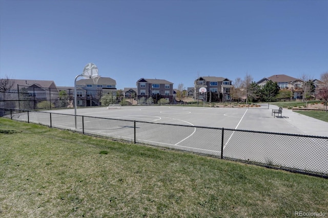 view of sport court featuring a lawn