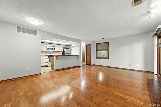2960 Shadow Creek Dr Unit 201, Boulder, CO 80303 - unfurnished living room with a textured ceiling and light wood-type flooring