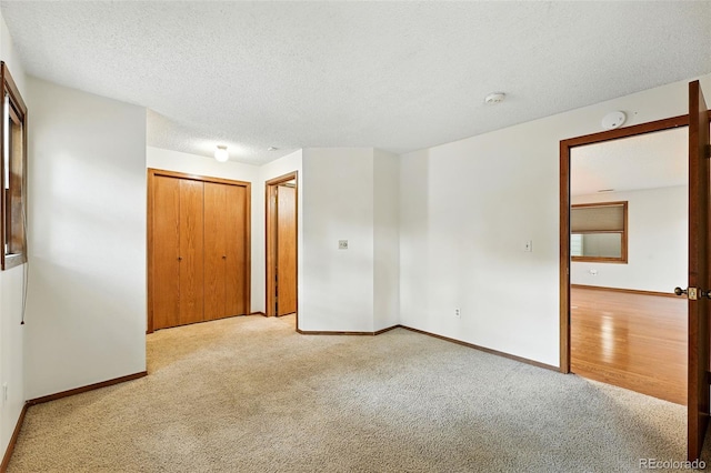 2960 Shadow Creek Dr Unit 201, Boulder, CO 80303 - unfurnished bedroom featuring light colored carpet, a closet, and a textured ceiling