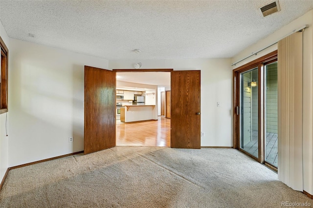 2960 Shadow Creek Dr Unit 201, Boulder, CO 80303 - unfurnished room featuring light colored carpet and a textured ceiling