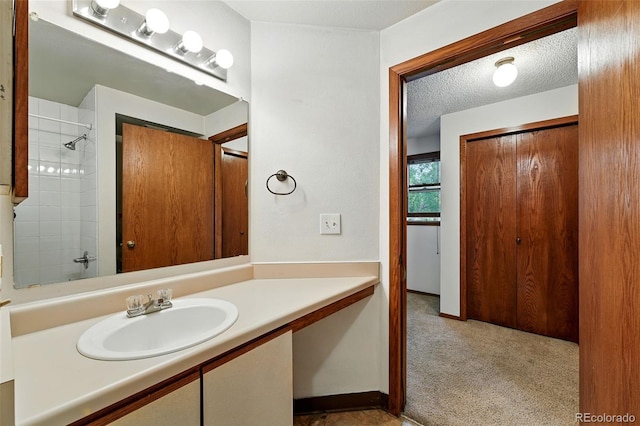 2960 Shadow Creek Dr Unit 201, Boulder, CO 80303 - bathroom with vanity, a textured ceiling, and a shower