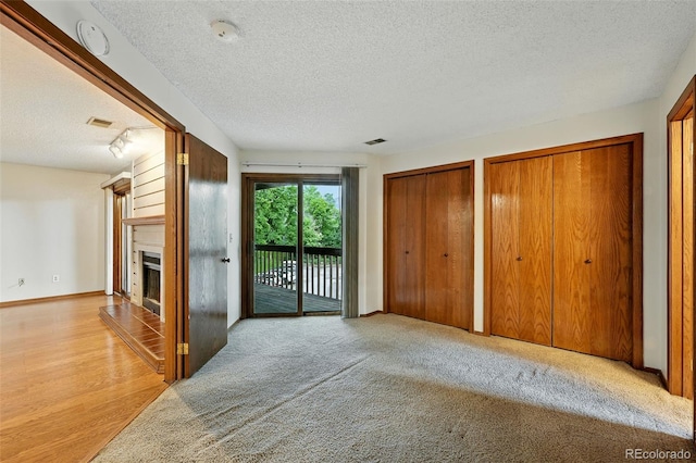 2960 Shadow Creek Dr Unit 201, Boulder, CO 80303 - unfurnished living room with a textured ceiling and a fireplace