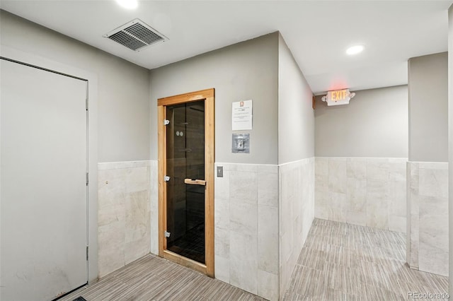 2960 Shadow Creek Dr Unit 201, Boulder, CO 80303 - corridor with tile walls, recessed lighting, and wainscoting