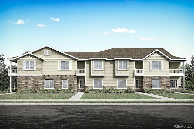 view of front facade with a front yard and a balcony