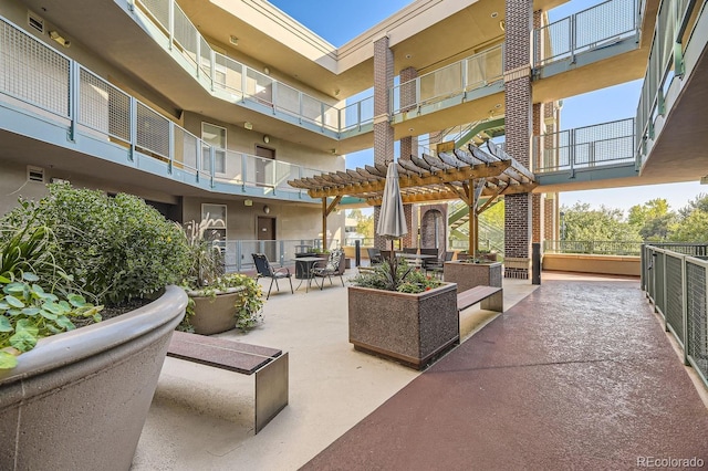 surrounding community with a pergola and a patio area
