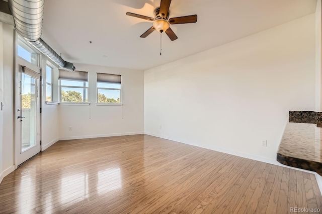 1313 S Clarkson St Unit 205, Denver, CO 80210 - empty room featuring light wood-style floors, a ceiling fan, and baseboards