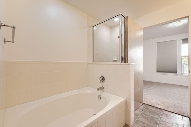 1313 S Clarkson St Unit 205, Denver, CO 80210 - full bath with a garden tub, tiled shower, tile patterned flooring, and baseboards