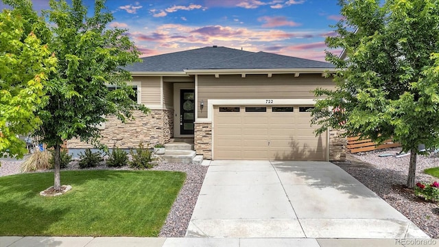722 Eva Peak Dr, Erie, CO 80516 - view of front of home with stone siding, driveway, a garage, a front lawn, and a shingled roof