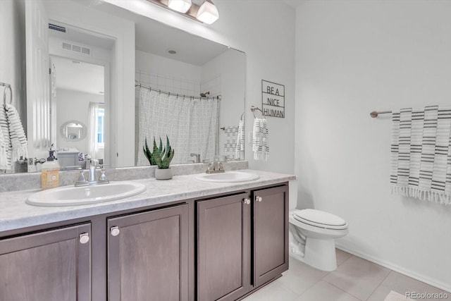 722 Eva Peak Dr, Erie, CO 80516 - full bath featuring double vanity, toilet, tile patterned floors, and a shower with curtain