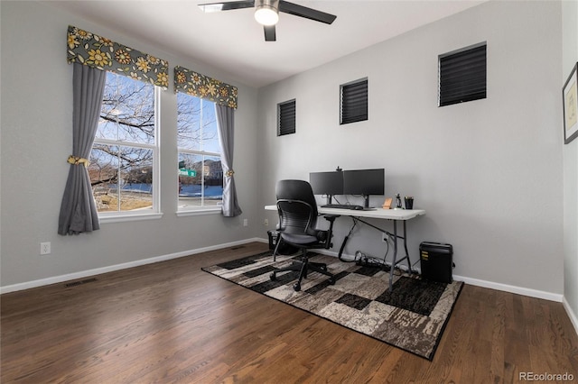 office space featuring ceiling fan, dark hardwood / wood-style floors, and a wealth of natural light