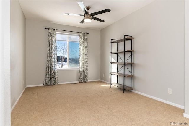 carpeted spare room with ceiling fan