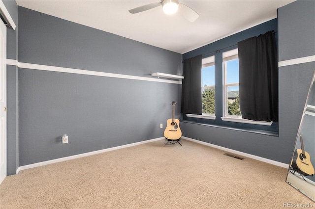 empty room with carpet and ceiling fan