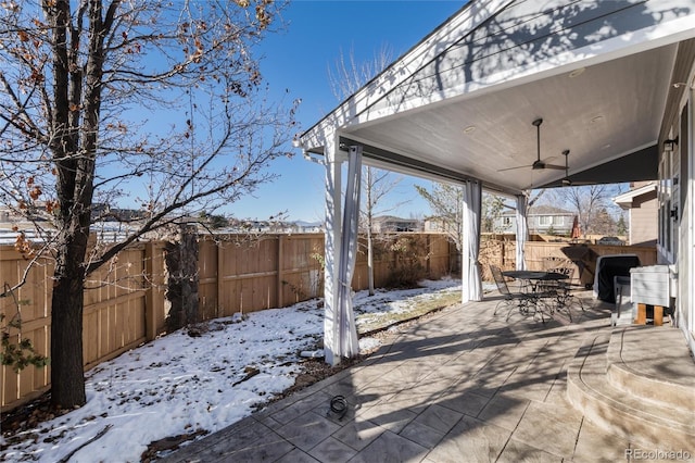 snow covered patio featuring ceiling fan