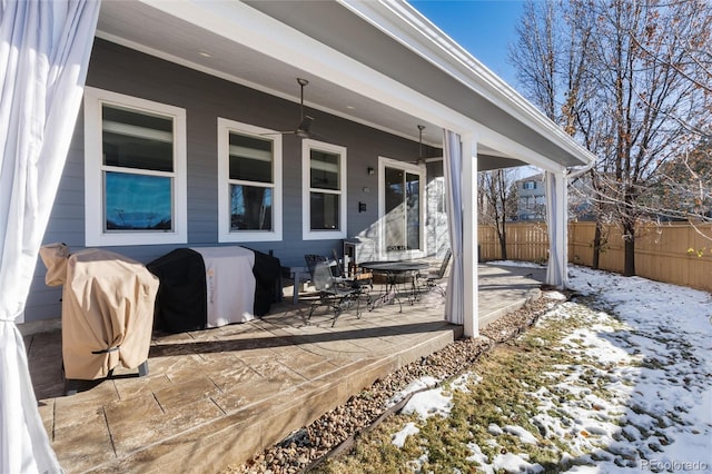 exterior space with ceiling fan and a grill