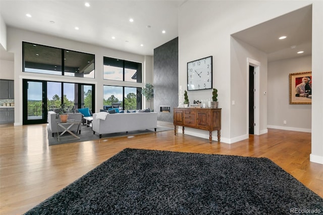 843 Long Timber Ln, Monument, CO 80132 - living room featuring a high ceiling, wood finished floors, and recessed lighting