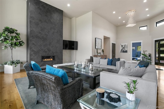 843 Long Timber Ln, Monument, CO 80132 - living area with a towering ceiling, recessed lighting, wood finished floors, and a tile fireplace