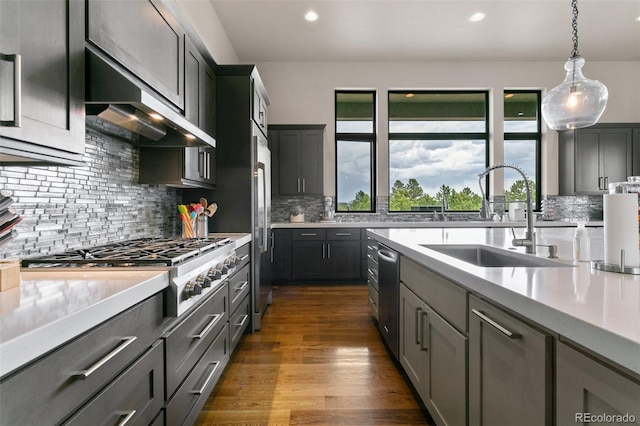 843 Long Timber Ln, Monument, CO 80132 - kitchen featuring exhaust hood, light countertops, decorative backsplash, recessed lighting, and hanging light fixtures