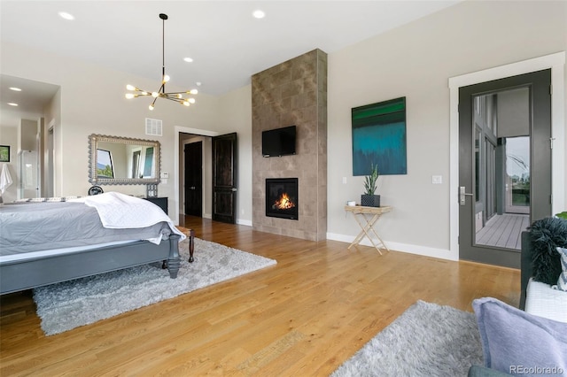 843 Long Timber Ln, Monument, CO 80132 - bedroom with a chandelier, a fireplace, wood finished floors, and recessed lighting