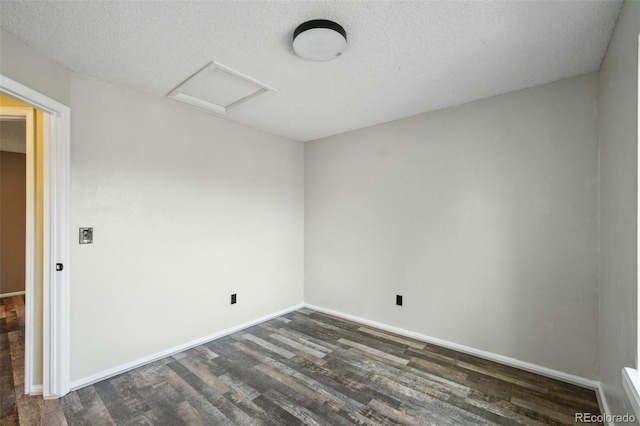68 N Quicksilver Ave, Castle Rock, CO 80104 - unfurnished room featuring dark wood-style floors, attic access, a textured ceiling, and baseboards