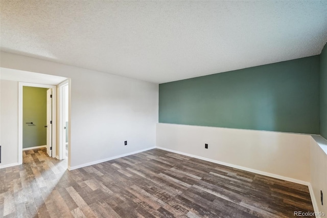68 N Quicksilver Ave, Castle Rock, CO 80104 - empty room with wood finished floors, baseboards, and a textured ceiling