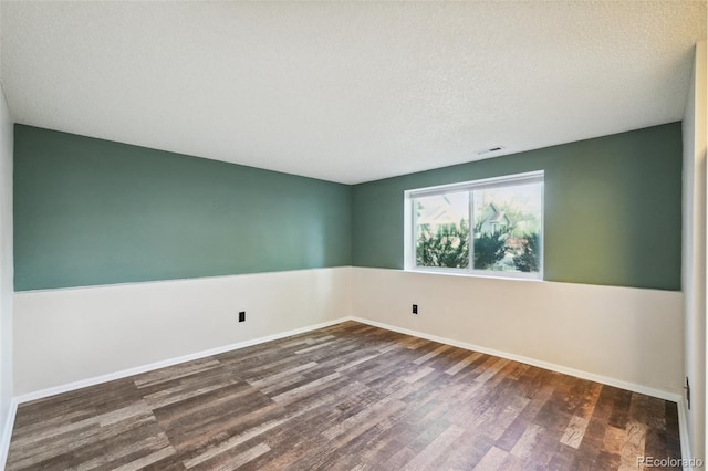 68 N Quicksilver Ave, Castle Rock, CO 80104 - spare room featuring dark wood-style flooring, baseboards, and a textured ceiling