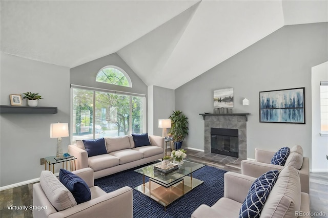 68 N Quicksilver Ave, Castle Rock, CO 80104 - living room with wood finished floors, baseboards, high vaulted ceiling, and a tile fireplace