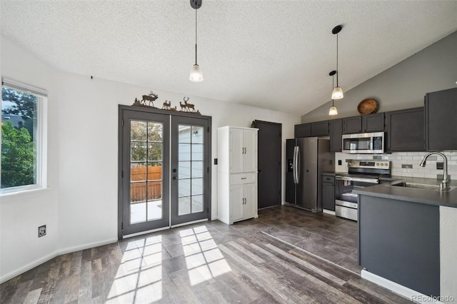68 N Quicksilver Ave, Castle Rock, CO 80104 - kitchen with appliances with stainless steel finishes, a sink, decorative light fixtures, a textured ceiling, and backsplash