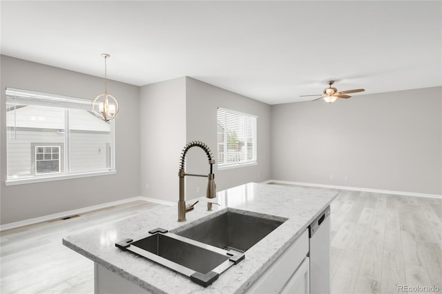 186 S 45th Ave, Brighton, CO 80601 - kitchen featuring light wood finished floors, open floor plan, and decorative light fixtures