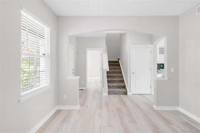 186 S 45th Ave, Brighton, CO 80601 - corridor with arched walkways, stairway, and light wood-type flooring